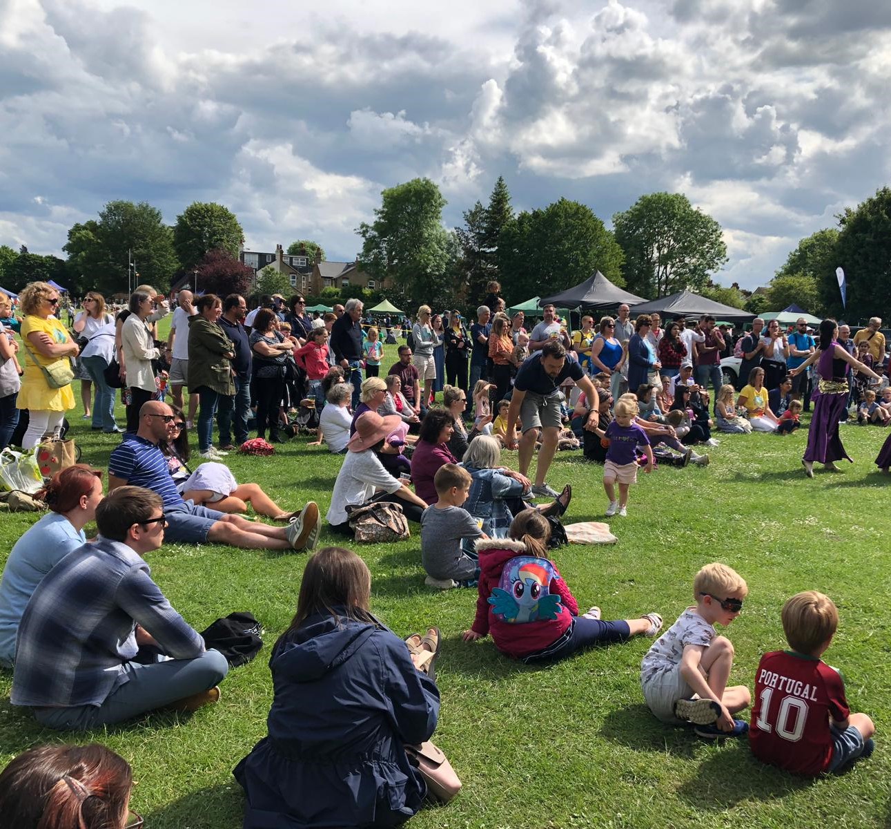 audience sitting on the grass at TCG summer fete